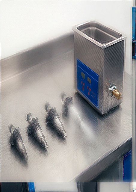 Fuel injectors beside an ultrasonic cleaning tank