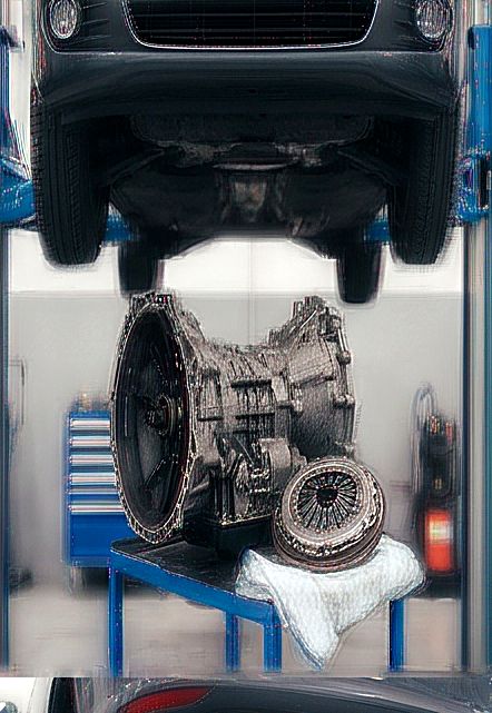Gearbox and clutch beneath a car raised on a lift